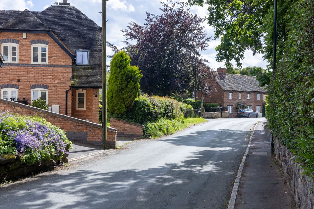 Homes and a village road in Lichfield District