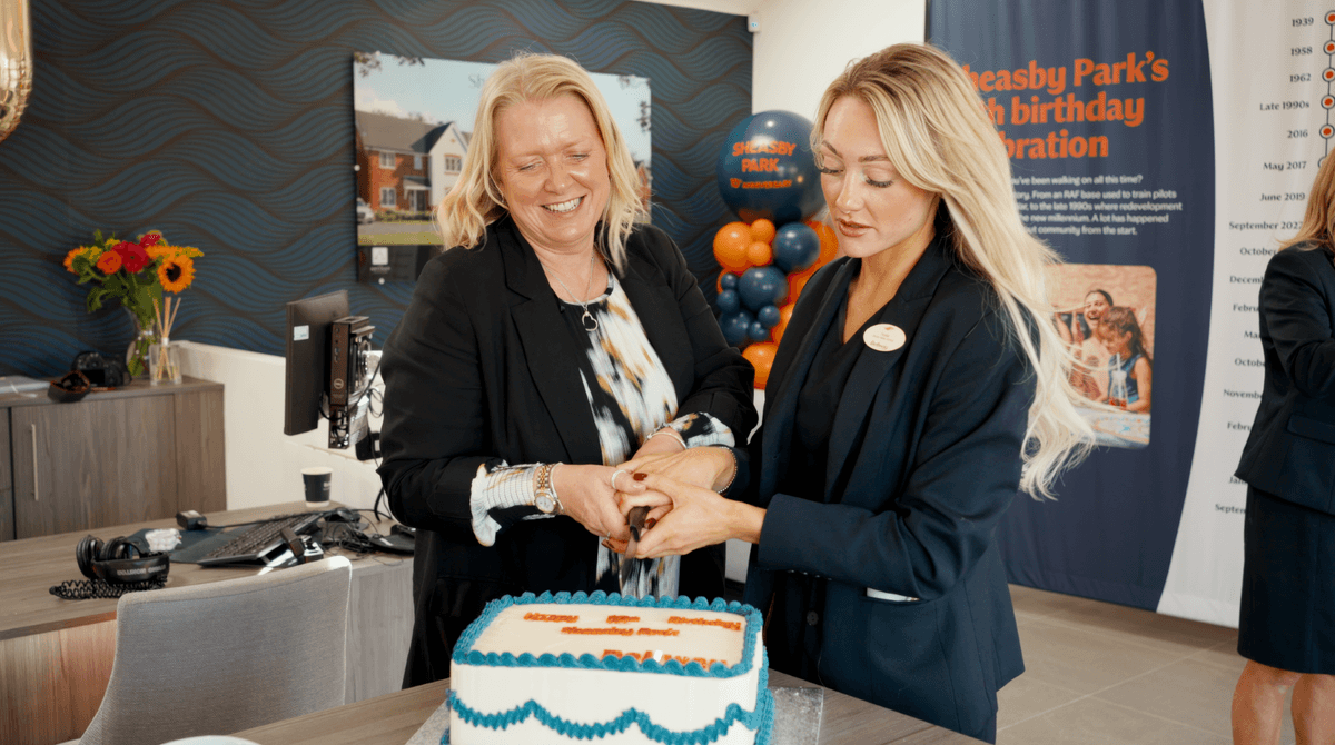 Two people cutting a cake at Sheasby Park’s tenth-anniversary celebration