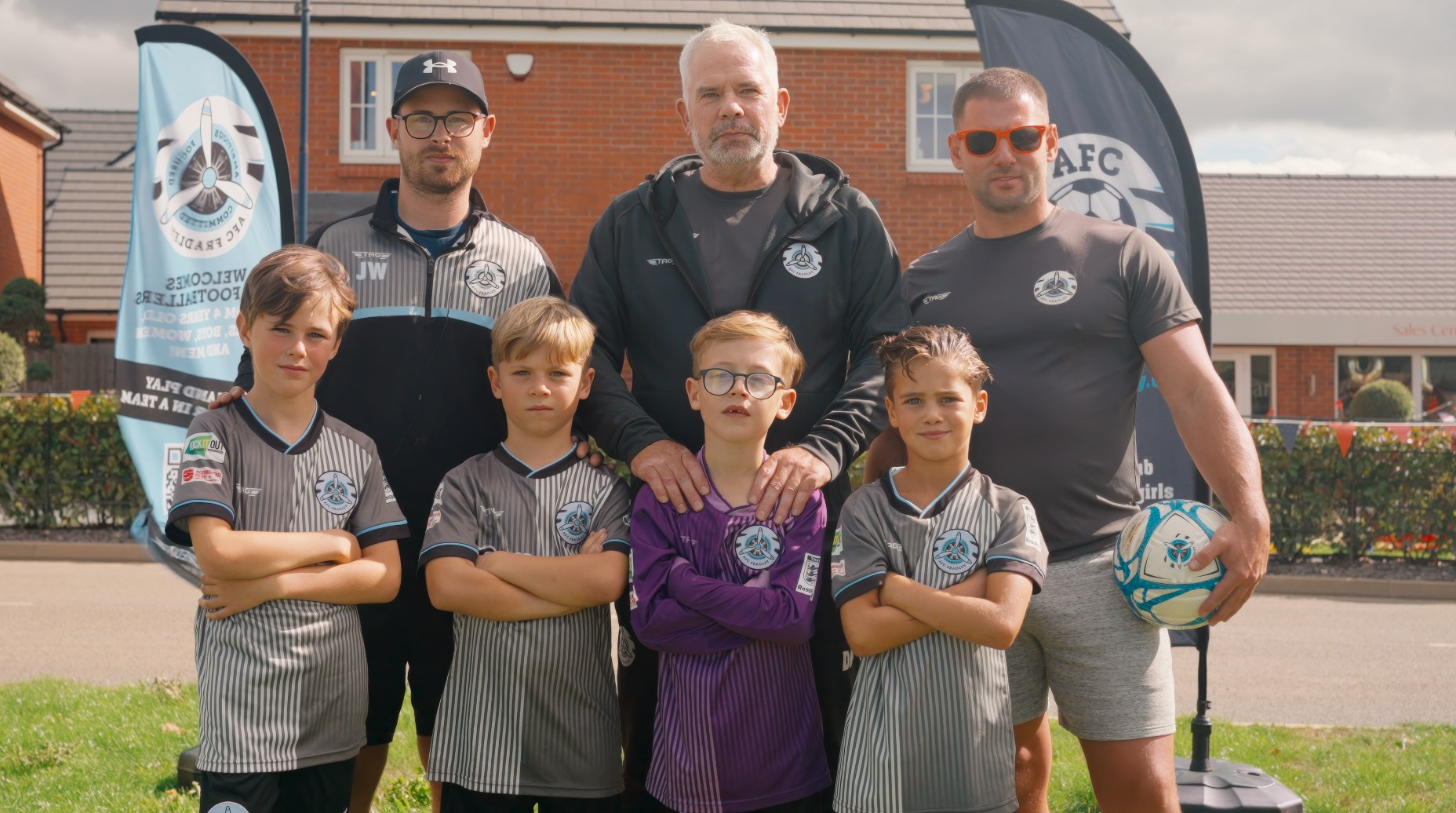 Young footballers and adults at the Sheasby Park anniversary event